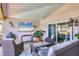 Cozy outdoor seating area with comfortable wicker furniture, a television, and decorative accents at 6900 Country Lakes Cir, Sarasota, FL 34243