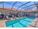 Serene pool and patio area with comfortable outdoor seating and lush landscaping at 6900 Country Lakes Cir, Sarasota, FL 34243