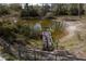 Pond with fishing dock, grass, and surrounding trees at 7211 Verna Bethany Rd, Myakka City, FL 34251