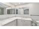 Well-lit bathroom featuring marble countertops and plenty of mirror space for easy grooming at 800 Hudson Ave # 102, Sarasota, FL 34236