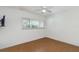 Bright bedroom with a ceiling fan and vinyl floors offering natural light through window at 800 Hudson Ave # 102, Sarasota, FL 34236