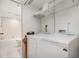 Convenient laundry area with washer, dryer and built-in shelving for optimal storage at 800 Hudson Ave # 102, Sarasota, FL 34236
