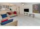 Open concept living area with tiled floors and comfortable furnishings, perfect for relaxing and entertaining guests at 800 Hudson Ave # 102, Sarasota, FL 34236