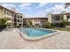 Community pool surrounded by lush landscaping, lounge chairs and well-maintained patio at 800 Hudson Ave # 102, Sarasota, FL 34236