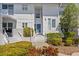 Inviting two-story condo featuring a private entrance, lush landscaping, and well-lit entryway at 803 Audubon Dr # 803, Bradenton, FL 34209
