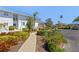 Well-maintained building exterior with lush landscaping and a inviting walkway at 803 Audubon Dr # 803, Bradenton, FL 34209