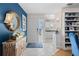 Bright foyer with coastal decor, white tile flooring, and a view into the modern, white kitchen at 803 Audubon Dr # 803, Bradenton, FL 34209