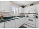 Bright kitchen with white cabinetry and essential appliances at 803 Audubon Dr # 803, Bradenton, FL 34209