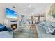 Bright and open living room with a fireplace, modern furniture, and seamless flow into dining area at 803 Audubon Dr # 803, Bradenton, FL 34209