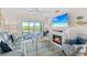 Inviting living room with a fireplace, comfortable seating, and access to a screened-in porch with a lovely view at 803 Audubon Dr # 803, Bradenton, FL 34209