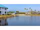 A tranquil pond reflecting nearby homes, with palm trees adding to the serene waterfront community view at 803 Audubon Dr # 803, Bradenton, FL 34209