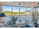 Relaxing screened-in porch with seating, a view of a tranquil pond, and ample natural light at 803 Audubon Dr # 803, Bradenton, FL 34209