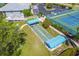Aerial view of community shuffleboard courts with shade, tennis courts, and ample parking at 803 Audubon Dr # 803, Bradenton, FL 34209