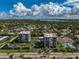 Overhead view of two condo buildings with pool and tennis court at 1001 Beach Rd # A203, Sarasota, FL 34242