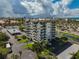 Aerial view of the condo building with parking and waterfront view at 1001 Beach Rd # A203, Sarasota, FL 34242