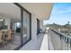 Relax on the balcony overlooking lush landscaping and blue skies through large sliding glass doors at 1001 Beach Rd # A203, Sarasota, FL 34242