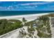 Aerial view showcasing a beautiful beach area with lush green surroundings at 1001 Beach Rd # A203, Sarasota, FL 34242