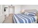 Inviting bedroom featuring an upholstered headboard, and a white-and-blue striped comforter at 1001 Beach Rd # A203, Sarasota, FL 34242
