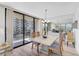 Dining area with a large glass window to the left and an open concept kitchen in the background at 1001 Beach Rd # A203, Sarasota, FL 34242