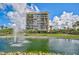 Beautiful view of a waterfront condo building with lush landscaping and a fountain at 1001 Beach Rd # A203, Sarasota, FL 34242