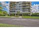 Exterior view of the condos featuring lush landscaping with a palm tree and a No Parking space at 1001 Beach Rd # A203, Sarasota, FL 34242