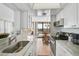 Bright kitchen featuring marble countertops and stainless steel appliances at 1001 Beach Rd # A203, Sarasota, FL 34242