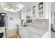 Well-lit kitchen featuring marble countertops and cabinetry with glass-front doors at 1001 Beach Rd # A203, Sarasota, FL 34242
