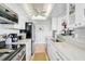 Bright kitchen with white cabinets, stainless steel appliances, and marble countertops at 1001 Beach Rd # A203, Sarasota, FL 34242