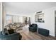 Spacious living room with comfortable seating, light wood floors, and an opening leading into the kitchen at 1001 Beach Rd # A203, Sarasota, FL 34242