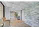 Hallway with stone accent wall, elevator, and recessed lighting at 1001 Beach Rd # A203, Sarasota, FL 34242