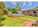 Lush backyard featuring a swimming pool and brick walkway at 1011 68Th W Ave, Bradenton, FL 34207
