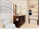 Well-lit bathroom featuring a granite vanity and built-in shelving at 1011 68Th W Ave, Bradenton, FL 34207