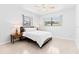 Bright bedroom featuring terrazzo flooring, a ceiling fan, and natural light from two windows at 1011 68Th W Ave, Bradenton, FL 34207