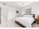 Comfortable bedroom with a ceiling fan, terrazzo floor, and natural light at 1011 68Th W Ave, Bradenton, FL 34207