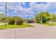 Charming home with a covered parking area, well-maintained lawn, and lush landscaping at 1011 68Th W Ave, Bradenton, FL 34207