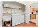Functional laundry room with a washer, dryer, utility sink, and ample storage space at 1011 68Th W Ave, Bradenton, FL 34207