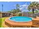 Beautiful backyard pool with wood deck surrounded by a wooden privacy fence at 1011 68Th W Ave, Bradenton, FL 34207