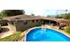 Backyard view of the sparkling blue pool, lush greenery, and relaxing patio area at 1011 68Th W Ave, Bradenton, FL 34207