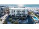 Stunning aerial view of the modern condominium building, parking, and beach at 1035 Seaside Dr # 603, Sarasota, FL 34242