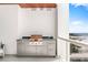 Balcony with a built-in outdoor grill, counter space, and view of the beach and ocean at 1035 Seaside Dr # 603, Sarasota, FL 34242