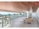 Coastal balcony with lounge seating and picturesque beach views at 1035 Seaside Dr # 603, Sarasota, FL 34242