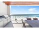 Outdoor kitchen and dining area on the balcony with stunning ocean views at 1035 Seaside Dr # 603, Sarasota, FL 34242