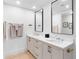 Modern bathroom with a double sink vanity, sleek mirrors, and elegant fixtures at 1035 Seaside Dr # 603, Sarasota, FL 34242