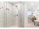 Bathroom featuring a frameless glass walk-in shower, and access to bedroom at 1035 Seaside Dr # 603, Sarasota, FL 34242