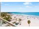 Expansive beach view with clear turquoise water, white sand, and palm trees under a sunny blue sky at 1035 Seaside Dr # 603, Sarasota, FL 34242