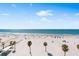 Stunning beach view showcasing white sand, beachgoers, and clear ocean waters under a blue sky at 1035 Seaside Dr # 603, Sarasota, FL 34242