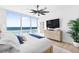 Primary bedroom with ocean view, ceiling fan, and modern furniture at 1035 Seaside Dr # 603, Sarasota, FL 34242