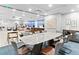Bright conference room with a large table, comfortable chairs, and office space in the background at 1035 Seaside Dr # 603, Sarasota, FL 34242