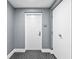 Hallway with gray wallpaper, white doors, and neutral patterned carpet leading to unit 603 at 1035 Seaside Dr # 603, Sarasota, FL 34242