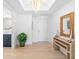 Well-lit hallway with stylish decor, wood accents, and view of a modern bathroom at 1035 Seaside Dr # 603, Sarasota, FL 34242
